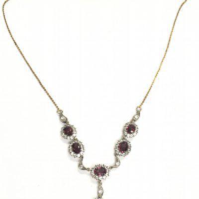 A gold and silver backed stone set necklace. Postage category A