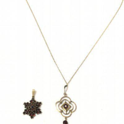 A 9ct gold garnet pendant on a gold chain (2.4g) and a 12k gold filled garnet star pendant. Postage category A