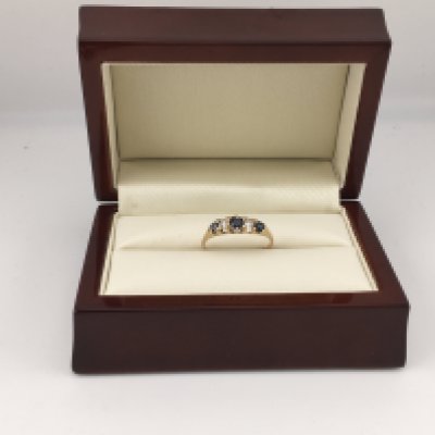 A yellow metal sapphire and diamond set ring (tested 18ct not hallmarked). Approx weight 2.09 grams, Approx size L.
