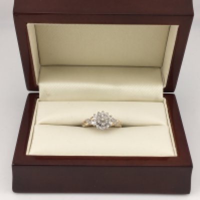 A 9ct gold diamond set cluster ring with diamond set shoulders. Approx weight 3.31 grams, Approx size L.