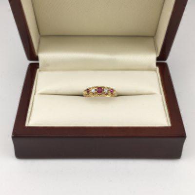 An 18ct ruby and diamond set ring. Approx weight 2.65 grams, approx size K.