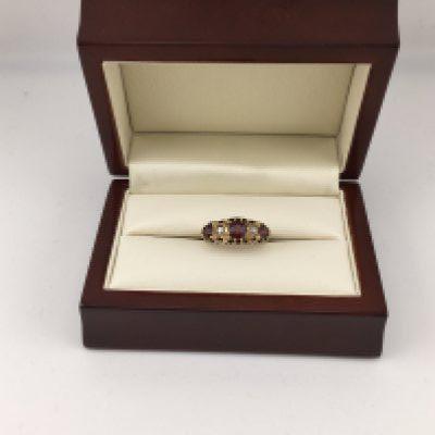 An 18ct garnet and diamond set ring. Approx weight 3.9 grams, size L.