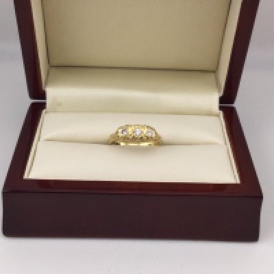 An 18ct gold ring set with three diamonds. Approx weight 3.69 grams, approx size L.