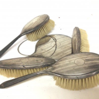 A silver dressing table set sold as seen no mirror.