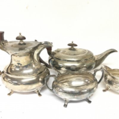 A Four piece silver tea set with hot water jug tea pot cream jug and sugar bowl Sheffield hallmarks good condition total weight approximately 1995g.