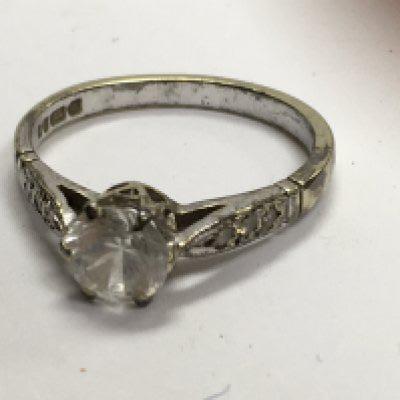 A 9 ct white gold ring inset with single diamond.siz L / M .