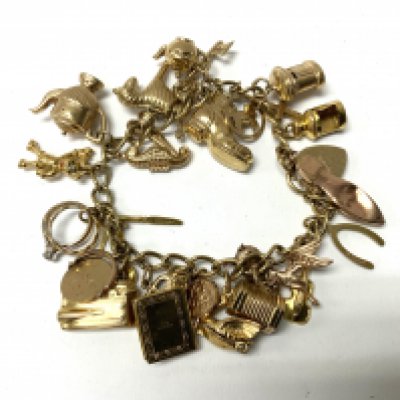 A 9ct gold charm bracelet and multiple charms, total weight 33.8g (A)