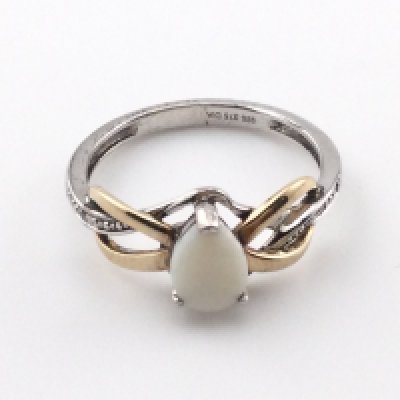A silver and 9ct gold ring with a central opal. Size L and 1.9g Postage A