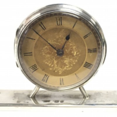 A hallmarked silver dressing table clock. 7cm wide. This lot cannot be posted. NO RESERVE