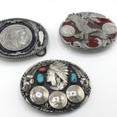 A collection of three belt buckles including two Siskiyou examples set with American coins and another set with turquoise and coral. Postage B. NO RESERVE
