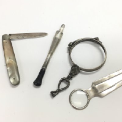 A silver hallmarked pen knife, silver book mark, silver lorgnettes and a silver cigarette holder. Postage category A. NO RESERVE