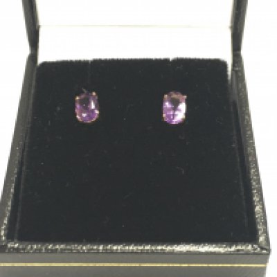 A pair of 18ct gold oval amethyst stud earrings. Approximately 0.80ct Postage A