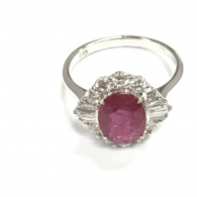 18ct white gold oval ruby and diamonds cluster ring. Ruby 2.05ct and 0.85ct baguette diamonds. Size N 1/2. Postage B