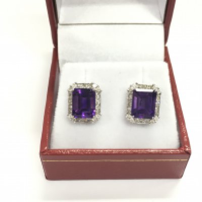 A pair of 18ct white gold large stud earring set with step cut eye clean amethyst's surround by diamonds. Postage A