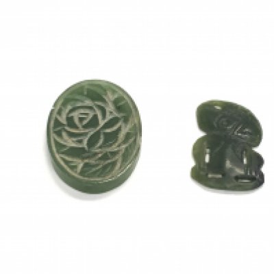 Two hand carved jadeite stones. Postage A
