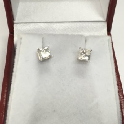 A pair of 14ct white gold princess cut diamond solitaire studs. 0.90ct diamonds with COA. Postage A