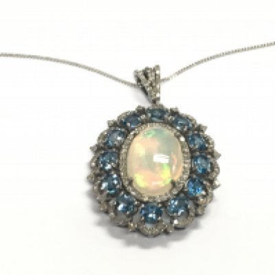 Large oval cluster pendant in silver set with oval cabochon opal surrounded by diamonds and oval london blue topaz on silver chain. 5.50ct opal 1.20ct diamonds and 4.86ct topaz.