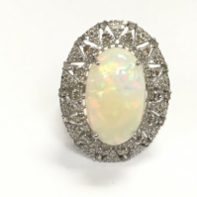 Ornate silver dress ring set with large oval cabochon opal and diamonds. Opal 9.67ct and diamonds 1.47ct appropriate. Size Q Postage A