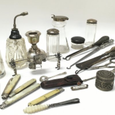 A Collection of silver items including fruit knives, candlesticks and silver top bottles