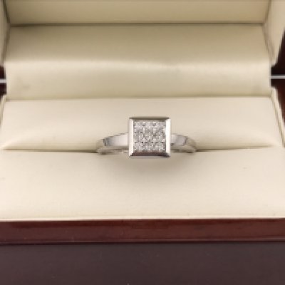 An 18ct white gold square diamond cluster ring set with brilliant cut diamonds approx 0.25cts. Approx weight 4.4grams.