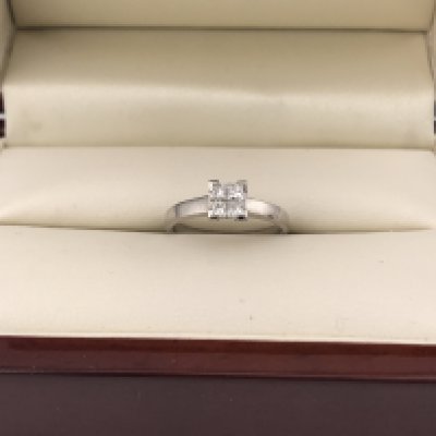 An 18ct white gold princess cut four diamond solitaire ring. Approx weight 2.4grams, approx size I 1/2.