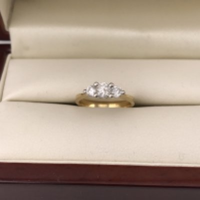 An 18ct three stone set diamond ring, approx weight 2.2grams, approx size H.