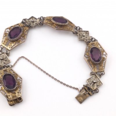 An Edwardian style silver bracelet set with purple stones. Postage A