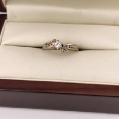 A 9ct gold diamond solitaire with diamond set shoulders. Approx weight 2.24 grams, size M.