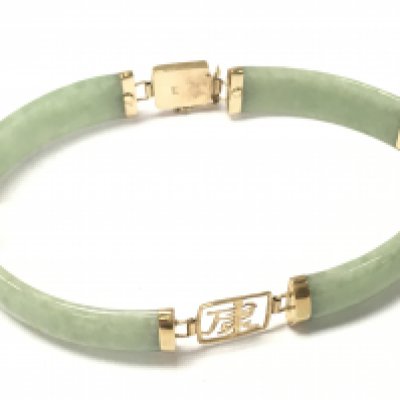 A jade and 9ct gold bracelet. Postage category A
