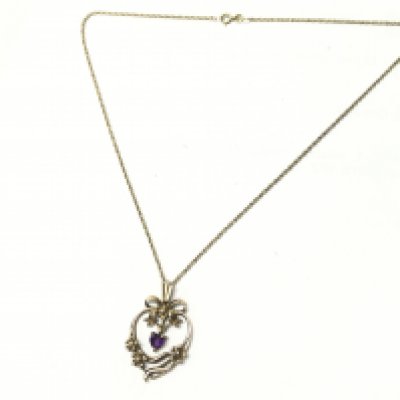 A gold gilted silver pendant and necklace. Postage category A