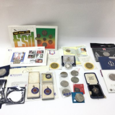 A collection of silver proof and other commemorative coins including four silver medals. Postage B