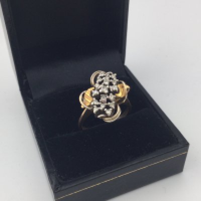 A yellow metal diamond cluster ring. Approx weight 5 grams, approx size M.