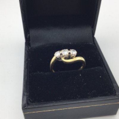 An 18ct gold three stone diamond ring. Approx weight 3.4 grams, approx size K.