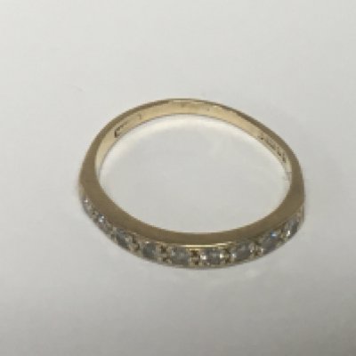 A 9carat gold half hoop eternity ring set with a row of nine brilliant cut diamonds. Weight 2g