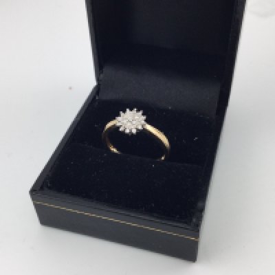 A 9ct gold diamond cluster ring. Approx size n.