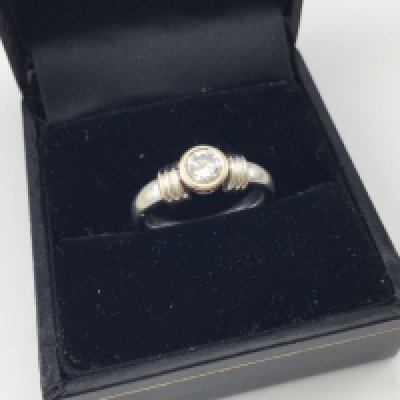An 18ct white gold rub set solitaire ring. Approx weight 5.6 grams, size I.