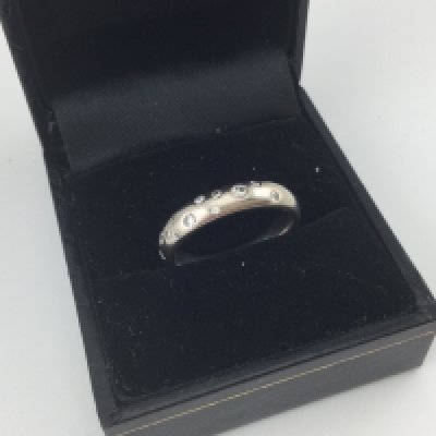 A white gold ring set with diamonds. Approx weight 6 grams, size M.