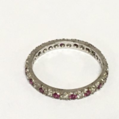 A white gold eternity ring set with alternating stones ring size O. Weight 1.8g