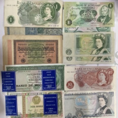 A small collection of British banknotes. (A)