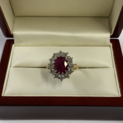A good quality 18ct yellow gold Ruby and Diamond cluster ring central ruby surround by approx 1.2cts of brilliant cut diamonds. Size P (A)