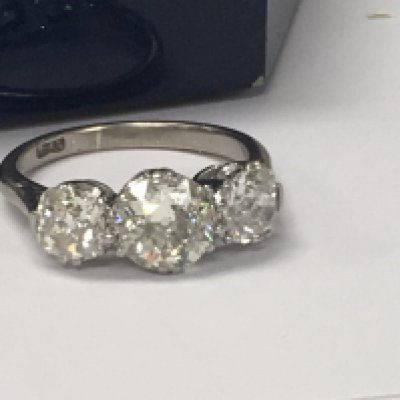 A platinum ring inset with three diamonds total weight 2ct Approx . Size L