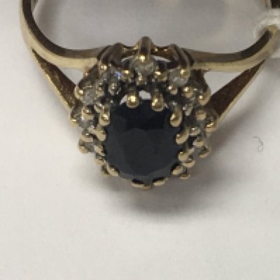 A 9 ct gold ring with sapphire and diamond chip inset size K .