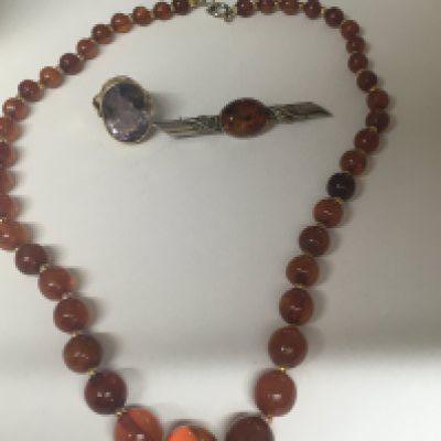 A gold Quartz ring a silver brooch inset with amber and a amber colour Necklace,