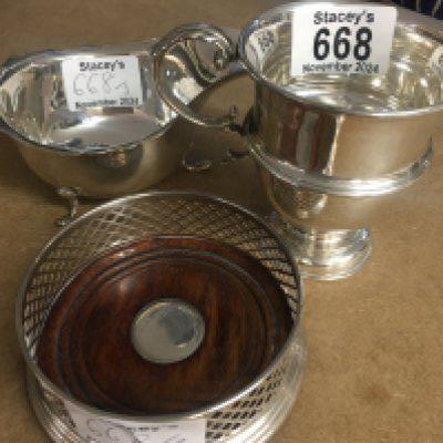 Three items of silver comprising mug , milk jug , and coaster.