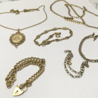A collection of gold chains, 23.4 g total weight. Postage category A