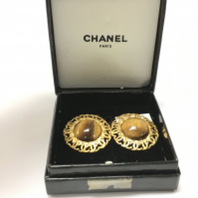 A boxed pair of Chanel tigers eye clip on earrings