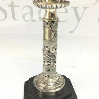 A Chinese silver candlestick with dragon design , 19cm tall. Postage category B