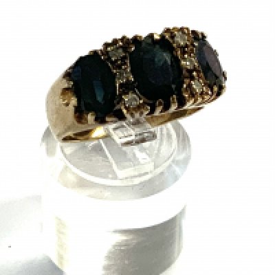 A 9ct gold sapphire and diamond cluster ring. (A)