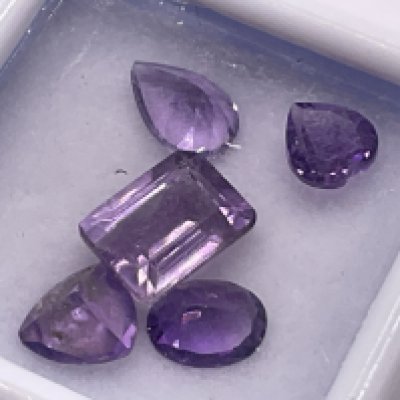 Parcel of 5 loose, unmounted amethyst gemstones in mixed cuts, boxed. 3.75ct. Postage category A.