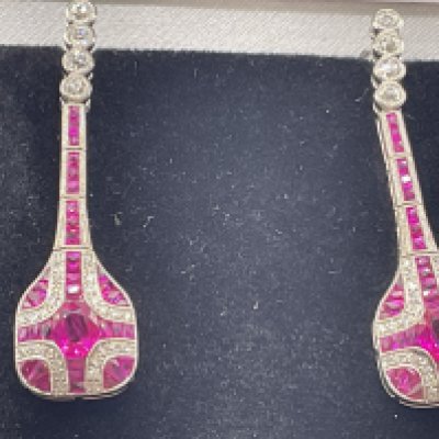 Pair of platinum ruby and diamond drop long drop dress earrings, boxed. Centre oval cut rubies 1.00ct. RBC and R/C diamonds 0.61ct. Remaining rubies 1.50ct. Postage category A.